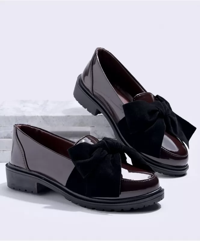 Black bow on brown patent loafers 